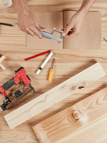 Woodworking scene with tools and wood pieces on a wooden surface